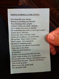 a person holding up a piece of paper with the words simple formula for living written on it