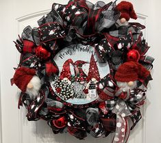 a red and black wreath with gnomes on it