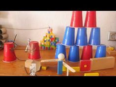 there are many different colored cones on the table and one is red, blue, and yellow