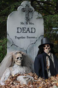 two skeletons dressed up for halloween in front of a gravestone with the words, mr and mrs dead together forever