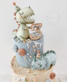 a birthday cake with a dinosaur on top