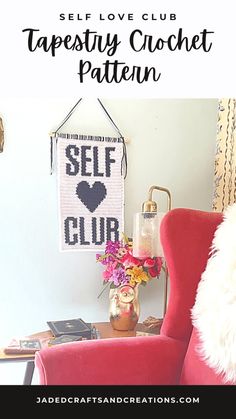 a red chair sitting in front of a white wall with the words self club on it