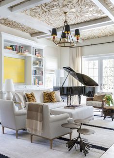 a living room filled with furniture and a grand piano