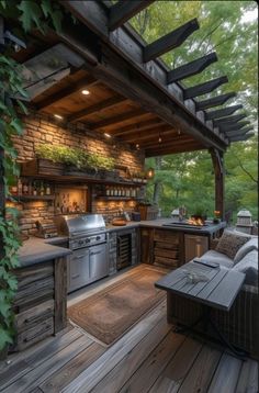 an outdoor kitchen with grill and seating area