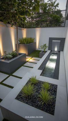 modern garden design with water feature and lighting