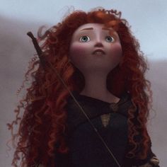 a doll with long red hair holding a bow and arrow in her hands, looking up at the sky