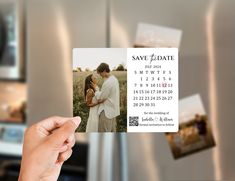 a person holding up a save the date card with photos on it in front of a refrigerator