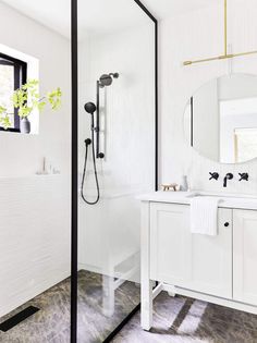 a bathroom with white walls and black trim