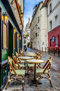 tables and chairs are lined up on the street