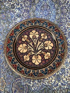 an intricately decorated plate with flowers on it