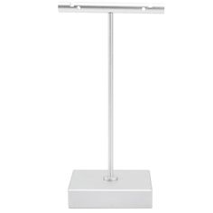 a white desk lamp on a stand with an electronic device attached to it's base