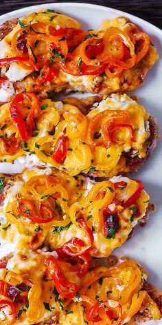 three pieces of bread with cheese and tomatoes on them, sitting on a white plate