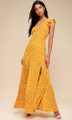 a woman wearing a yellow dress with white polka dots