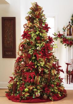 a christmas tree decorated with red and gold ribbons, poinsettis and wreaths