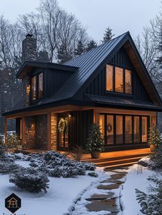 a house that is lit up in the snow