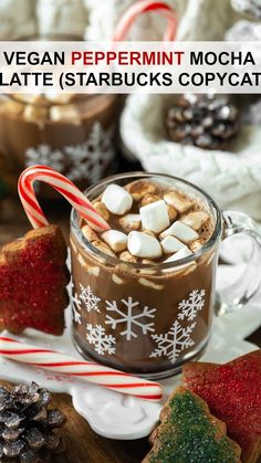 a cup of hot chocolate with marshmallows and candy cane