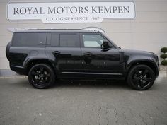 a black suv parked in front of a building