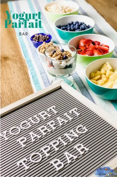 an image of yogurt parfait bar with fruits and cereals on the table