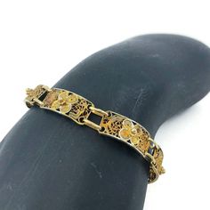 Vintage gold tone filigree bracelet, This lovely bracelet consists of eight beautiful rectangular filigree panels each with a repousse floral detail. It has a spring-ring clasp. Unlike anything made today! A great piece for gifting! CONDITION Good vintage condition. DIMENSIONS 7″ x 1/4″ Jewelry comes in a box ready for gift-giving Questions for me? Scroll down and click Message Tracey, I will get back to you typically within a few minutes. Ready to buy? Click Add to Cart and pay with Pay Pal or credit card. Satisfaction is guaranteed. Your vintage treasure will be carefully packaged and on it's way to you typically within 24 hours. Need something for your home? Visit www.vivaterravintage.etsy.com for a selection of vintage lovelies for the home. Victorian Filigree Bracelets In Yellow Gold, Victorian Yellow Gold Bracelet With Filigree, Victorian Yellow Gold Filigree Bracelets, Ornate Gold Bracelet, Elegant Rectangular Engraved Bracelets, Adjustable Rectangular Gold Bracelet For Formal Occasions, Elegant Engraved Rectangular Bracelets, Elegant Rectangular Engraved Gold Bracelet, Antique Gold Filigree Bracelets