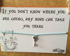 a sign with a key attached to it that says if you don't know where you are going, any road can take you there