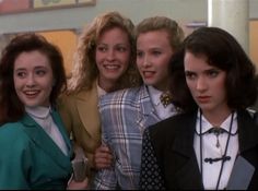 four women are posing for the camera together