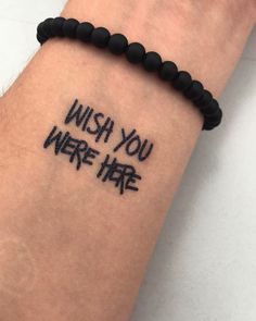 a wrist tattoo with the words wish you were here written on it