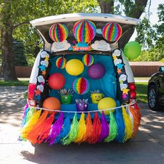 the back end of a car decorated with colorful decorations