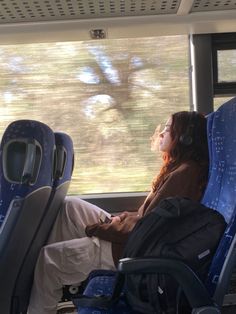 a woman with headphones sitting on a bus