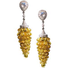 PANIM Natural FancyColor Diamond Briolette Grape Earrings in 18K WhiteGold 35cts Unique handcrafted Natural Fancy Color Diamond Briolettes Grape Style earrings. Natural Fancy Color Briolettes ranges from Golden Yellow to Fancy Yellow with multi tone yellow diamonds. Total Diamond Carats - 35.05 cts Total Gold Grams - 6.58 gms 18K Gold Video available on request of the beautiful piece. Contact us on platform for more information Yellow Diamond Earring, White Gold Drop Earrings, Modern Hoop Earrings, Briolette Necklace, Grape Earrings, Diamond Tops, Marquise Shape Diamond, Flawless Diamond, Diamond Cluster Earrings