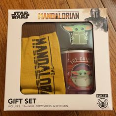 the box contains two pairs of socks and a baby yoda doll