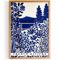 a blue and white print with trees, bushes and mountains in the background on a wooden frame