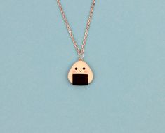 "Hi CutiePie, I'm Cute onigiri necklace. I'm pendant created from polymer clay without using any molds and completely handmade. I can be a funny gift for people of all ages. I'll always cheers You up and will bring a smile on your face. My dimensions are: Length 1\" ( or 2.5 cm. ) Width 1\" ( or 2.5 cm. ) Chain length: 18\" ( 45 cm. ) ❀I come in a pretty box but please note in the event that several items are purchased all of us will ship in one box. ❀ Because I'm made by hand, I may differ slig Kawaii Black Jewelry Gift, Novelty Resin Necklaces For Gifts, Novelty Resin Necklace For Gift, White Kawaii Polymer Clay Jewelry, Cute Onigiri, Kawaii Onigiri, Funny Necklace, Food Necklace, Rice Ball