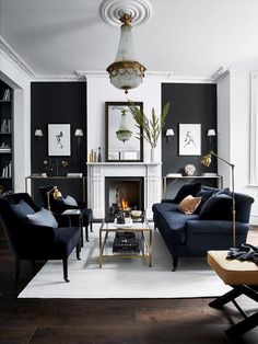 a living room filled with furniture and a fire place under a chandelier hanging from the ceiling