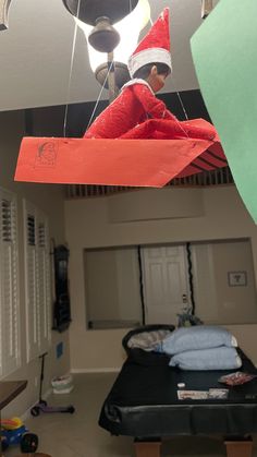 an elf hanging from the ceiling in a bedroom