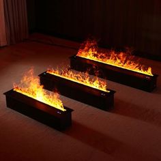 three rectangular fire boxes sitting on top of a floor