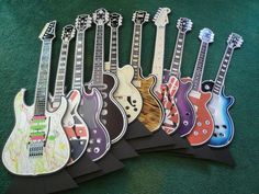 a group of guitar magnets sitting on top of a green carpeted floor next to each other