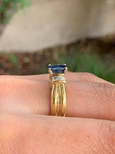 Attractive 18k Yellow gold ring with diamonds (.28ct) and a center natural oval blue sapphire (1.44ct ). Size 5 1/2 . Ring is well made and sturdy. Rich -feeling when worn, heavy, not flimsy. Fancy Color Diamond Ring, Sapphire And Diamond Ring, 18k Yellow Gold Ring, Blue Band, Halo Diamond Engagement Ring, Ring Photos, Fancy Color Diamonds, Yellow Gold Ring, Buying Jewelry