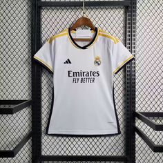 the real madrid jersey hanging on a rack