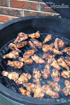 chicken is cooking on an outdoor grill with brick wall in the background and text overlay