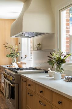 a kitchen with an oven, sink and stove top in it's center island