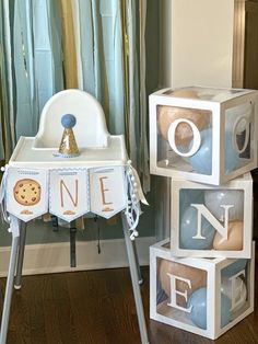 a baby's first birthday gift set up in front of a window with the number one on it