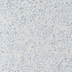 a white and blue tile pattern with hexagonal shapes on it's surface