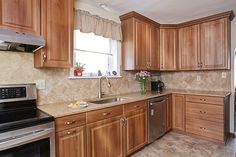 a kitchen with wooden cabinets and stainless steel appliances