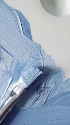 a paintbrush is being used to paint the ceiling