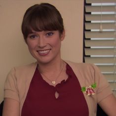 a woman wearing an apron and smiling at the camera