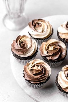 cupcakes with chocolate frosting on a white plate