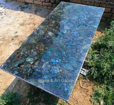 a table that has been made out of rocks and glass in the middle of it