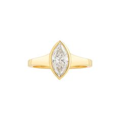 a yellow gold ring with a pear shaped diamond