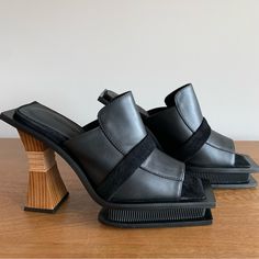 Nwt !! Never Worn, In Original Packaging Comes With Box Black Leather/ Black Suede Platform Mules Black-Owned Luxury Company/Designer Marked Size 37, But Fits A Us 7 - 8!! Please Be Aware: They Run Big Black Luxury Mules With Sculpted Heel, Luxury Black Mules With Sculpted Heel, Modern Black Mules With Padded Heel, Designer Black Mules With Sculpted Heel, Black Leather Mules With Sculpted Heel, Black Mules With Contrasting Heel Counter For Evening, Evening Black Mules With Contrasting Heel Counter, Black Mules With Rubber Heel Cap, Leather Mules With Rubber Heel Cap For Formal Wear