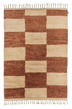 a brown and white checkered rug with fringes